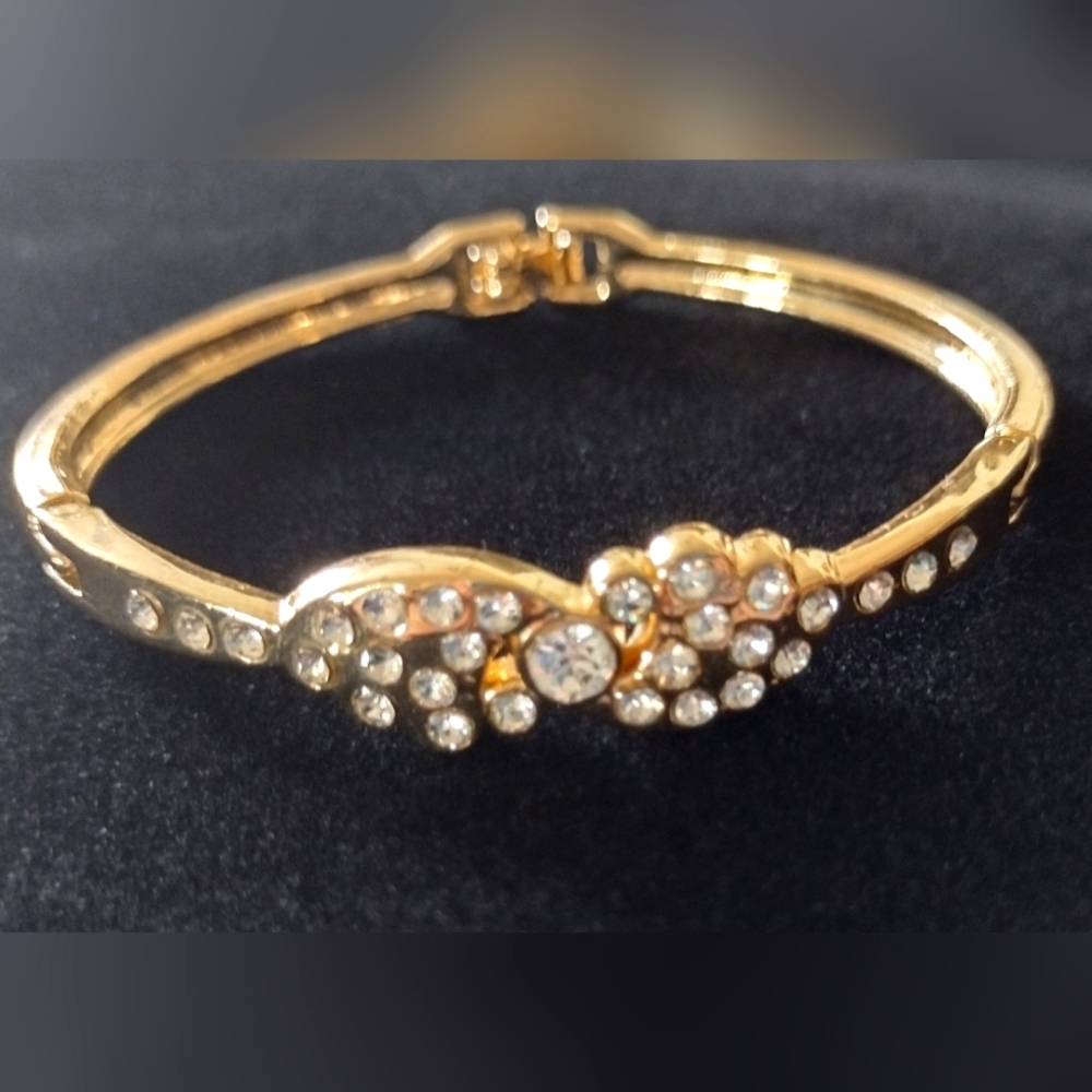 Gold tone cuff bracelet with crystal stones